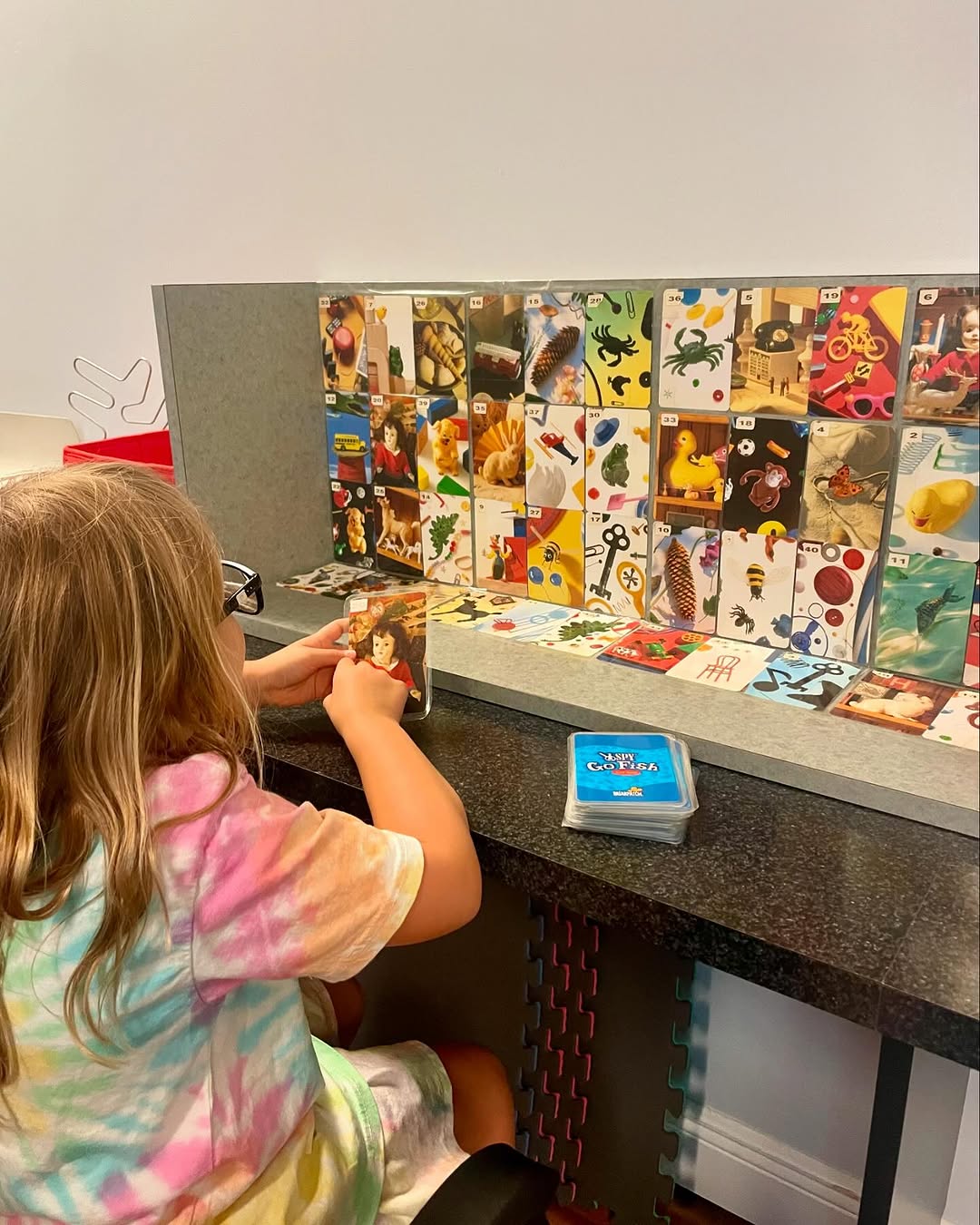 A young patient working a matching-card exercise in the therapy room