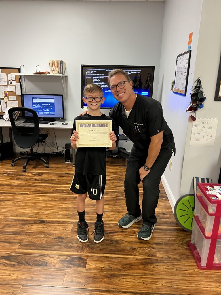 Noah holding his Certificate of Achievement