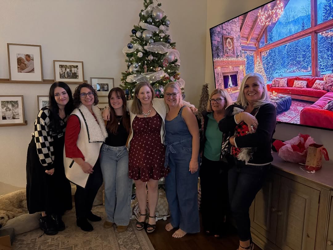Seven members of the Walesby crew gathered in front of a Christmas tree